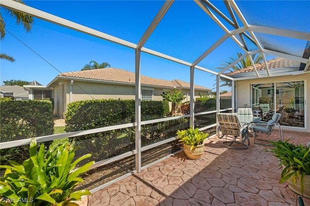 unfurnished sunroom with lofted ceiling