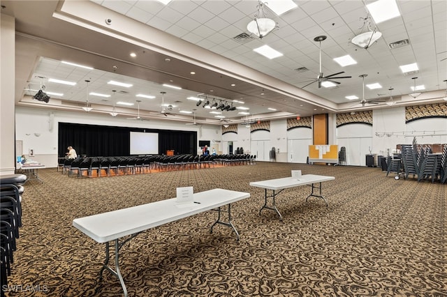 miscellaneous room featuring visible vents, ceiling fan, and carpet flooring