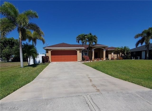 ranch-style home with stucco siding, driveway, a front yard, and a garage