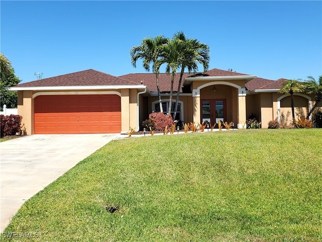 view of front of property featuring a front lawn, a garage, driveway, and stucco siding