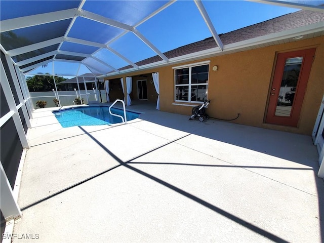 view of pool with a fenced in pool, a patio, and glass enclosure