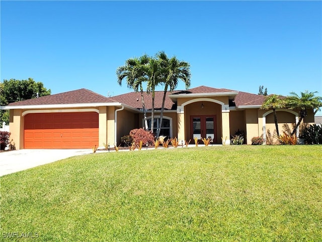 view of front of home with stucco siding, an attached garage, concrete driveway, and a front yard