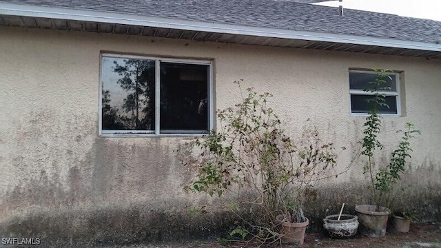 view of side of property with a shingled roof