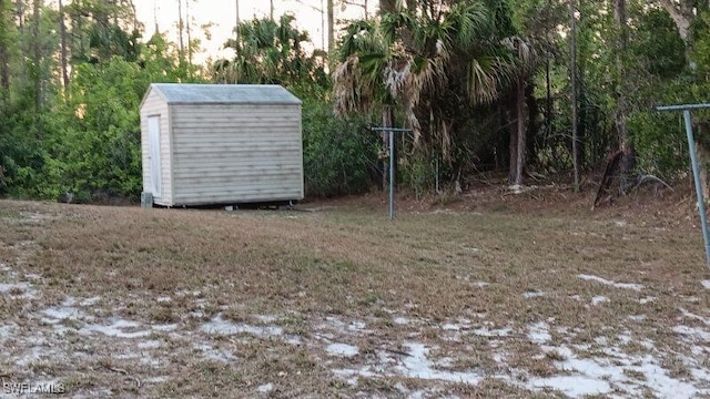 view of yard featuring an outbuilding and a shed