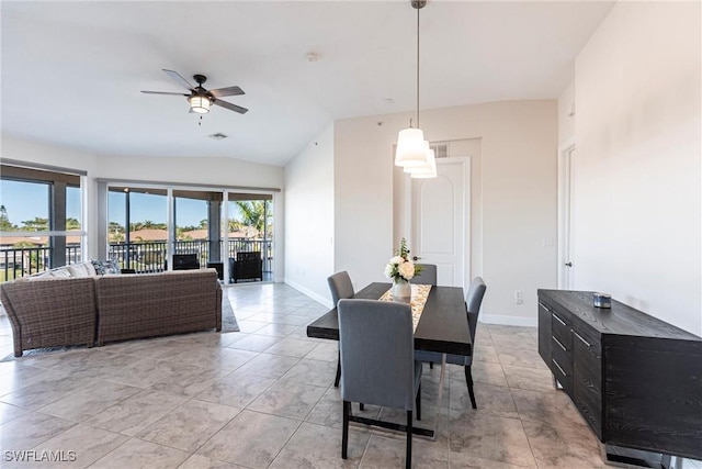 dining room featuring vaulted ceiling, a ceiling fan, and baseboards