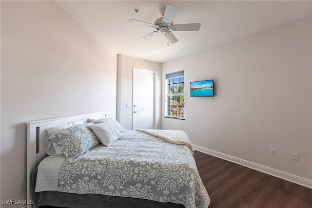 bedroom with a ceiling fan, baseboards, and dark wood-style flooring