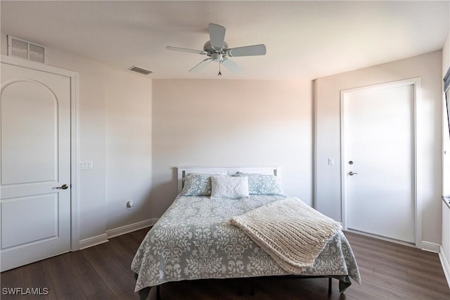 bedroom featuring visible vents, baseboards, and dark wood finished floors