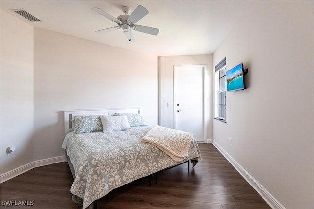 bedroom with visible vents, ceiling fan, baseboards, and wood finished floors