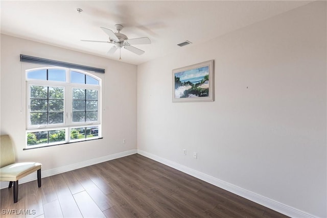 living area with dark wood-style floors, visible vents, ceiling fan, and baseboards