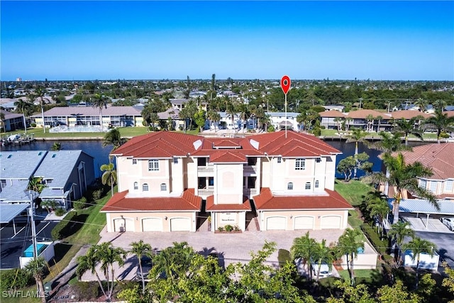 drone / aerial view with a residential view and a water view