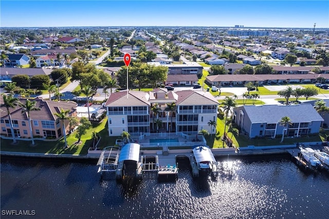 birds eye view of property with a residential view and a water view