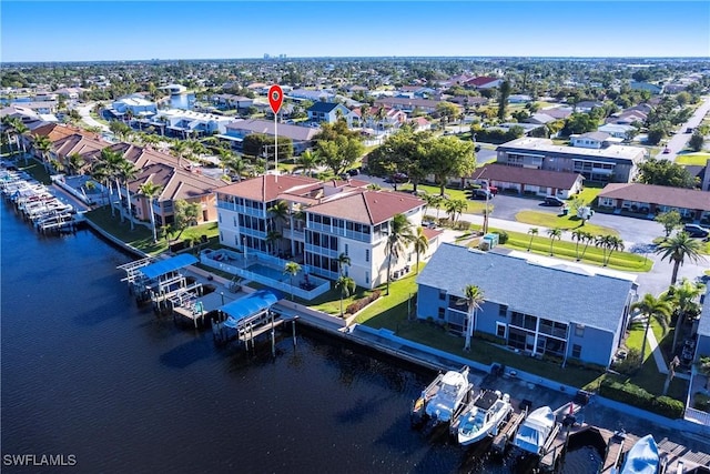 drone / aerial view featuring a water view and a residential view