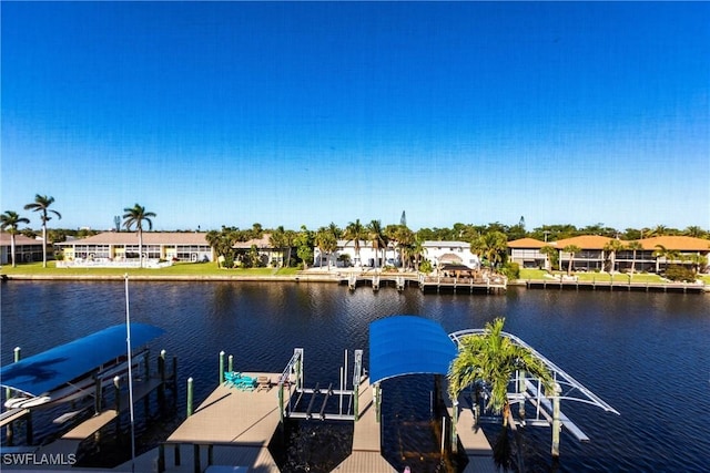 view of dock with boat lift, a residential view, and a water view