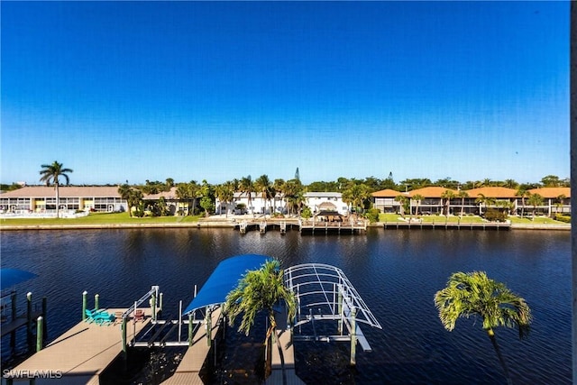 dock area with a residential view, a water view, and boat lift