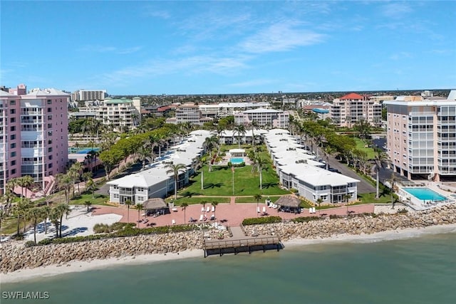 drone / aerial view featuring a city view, a beach view, and a water view