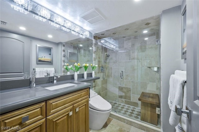 bathroom with visible vents, a stall shower, toilet, and vanity