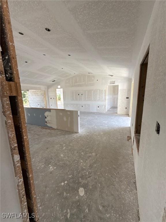 interior space featuring a textured ceiling and lofted ceiling