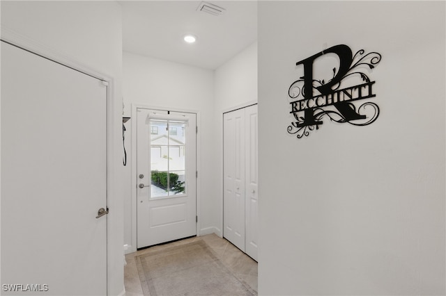 doorway to outside with recessed lighting and visible vents