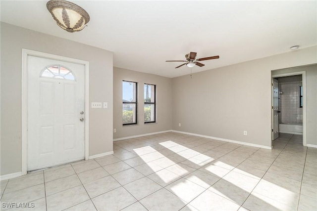 foyer entrance featuring light tile patterned floors and baseboards