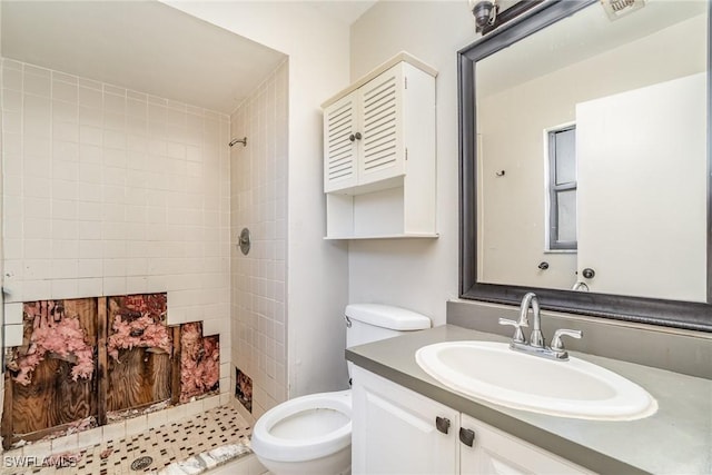 full bathroom with vanity, a shower stall, toilet, and visible vents