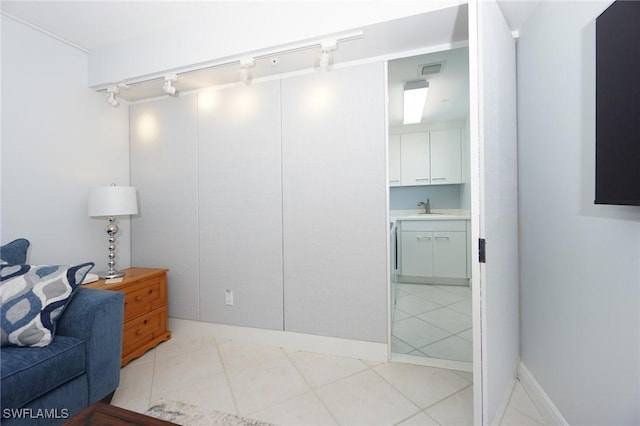 home office with light tile patterned floors, visible vents, and a sink