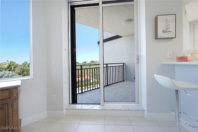 interior space with tile patterned floors and baseboards