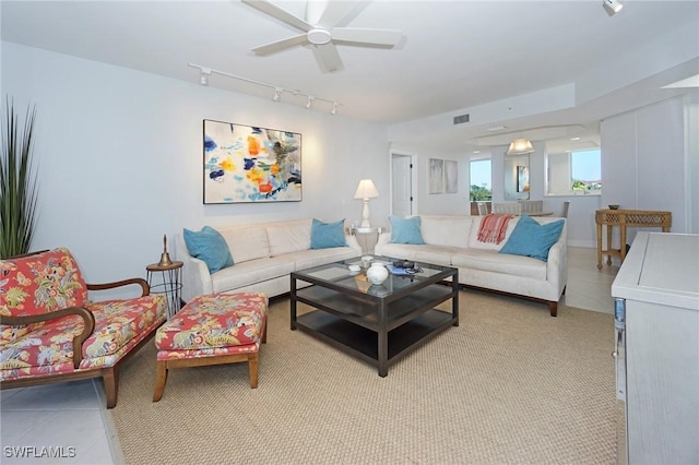 living room featuring light tile patterned floors, visible vents, track lighting, and ceiling fan