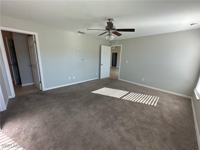 unfurnished bedroom with visible vents, baseboards, carpet, and a ceiling fan