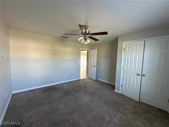 unfurnished bedroom with a closet, visible vents, carpet flooring, and baseboards