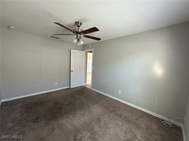 carpeted empty room with a ceiling fan, visible vents, and baseboards