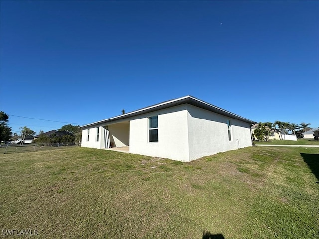 view of property exterior featuring stucco siding and a yard