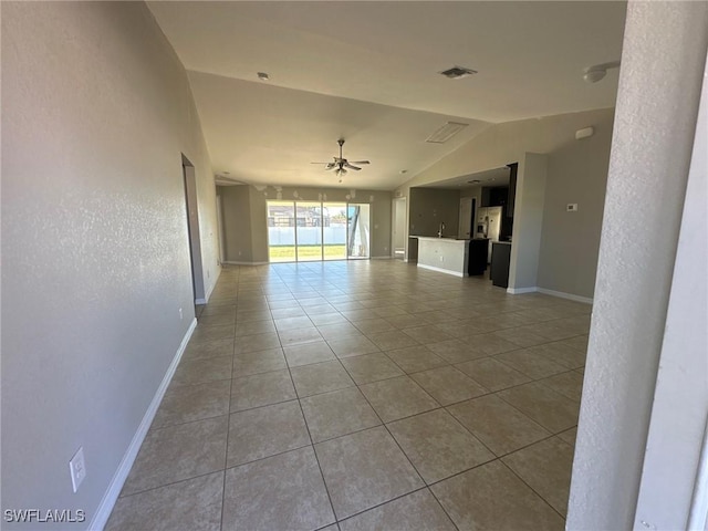 unfurnished living room with visible vents, a ceiling fan, baseboards, tile patterned flooring, and lofted ceiling