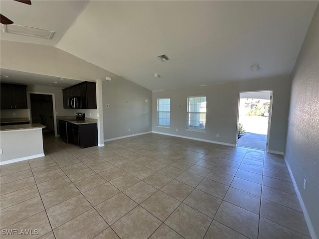 unfurnished living room featuring a ceiling fan, baseboards, visible vents, lofted ceiling, and light tile patterned flooring