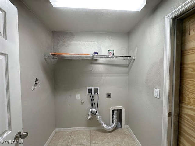 washroom featuring baseboards, light tile patterned floors, laundry area, hookup for a washing machine, and hookup for an electric dryer