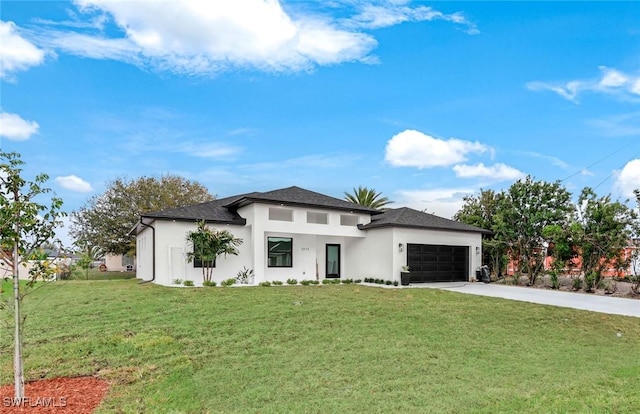 prairie-style home featuring a front lawn, concrete driveway, and a garage