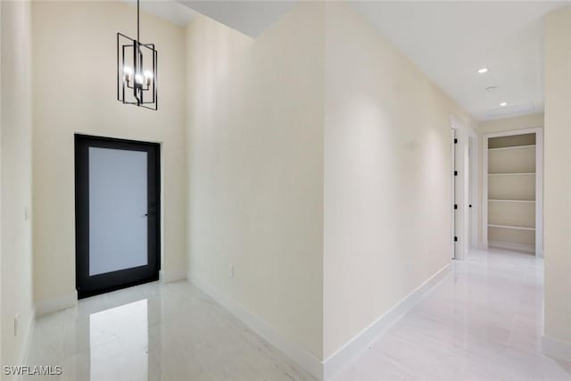 hallway featuring recessed lighting, baseboards, and a chandelier