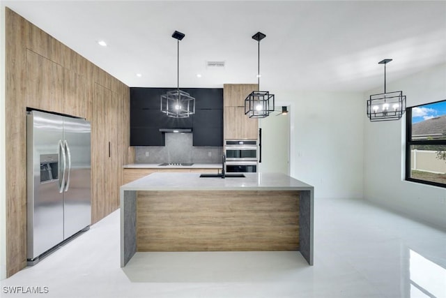 kitchen featuring visible vents, light countertops, decorative backsplash, stainless steel appliances, and modern cabinets