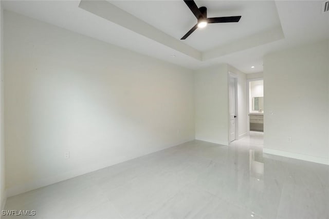 empty room with baseboards, visible vents, a tray ceiling, recessed lighting, and ceiling fan