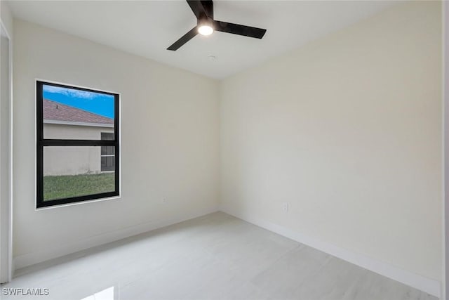 unfurnished room with baseboards and ceiling fan