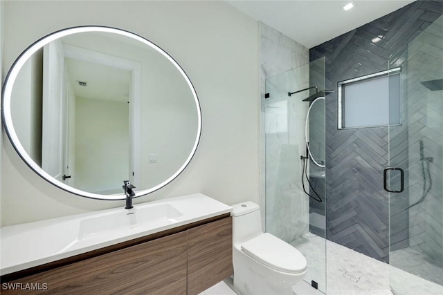 bathroom featuring a shower stall, toilet, and vanity