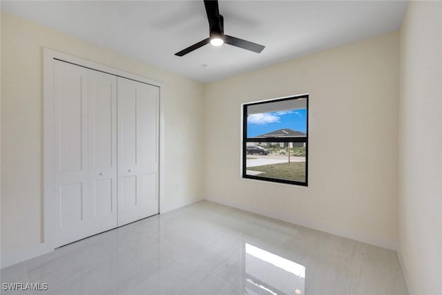 unfurnished bedroom featuring a closet and ceiling fan