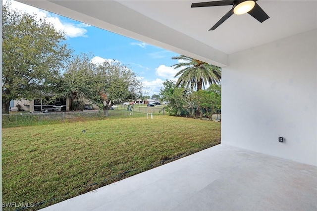 view of yard with a patio, a ceiling fan, and fence