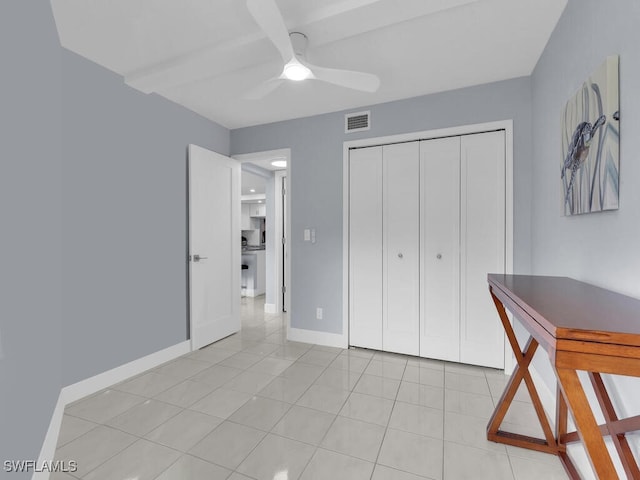 bedroom featuring visible vents, ceiling fan, baseboards, light tile patterned floors, and a closet