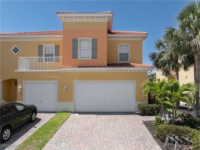 16114 Via Solera Cir Unit 106, Fort Myers, FL 33908 - view of front of property with a tiled roof, an attached garage, stucco siding, and decorative driveway