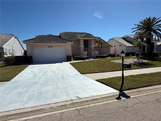 view of front facade featuring driveway, an attached garage, stucco siding, a front lawn, and a tiled roof