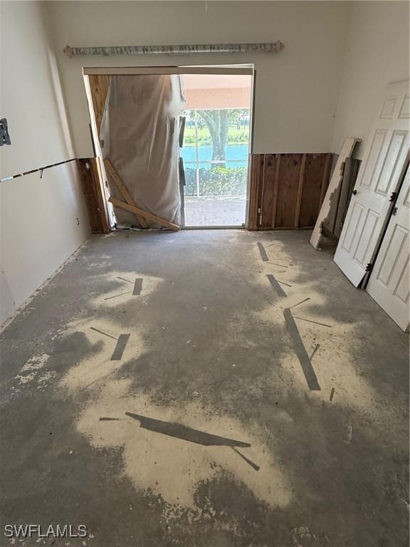 unfurnished room featuring unfinished concrete floors