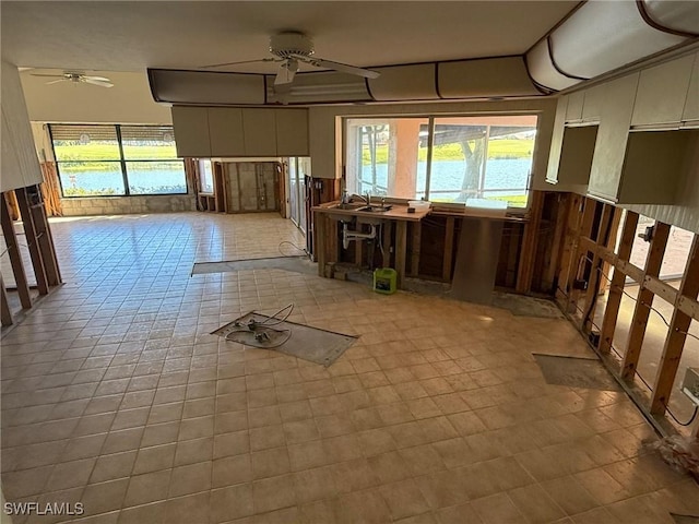 interior space featuring light tile patterned floors and a ceiling fan