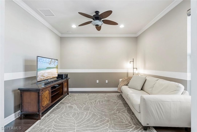 living room with wood finished floors, baseboards, visible vents, recessed lighting, and crown molding