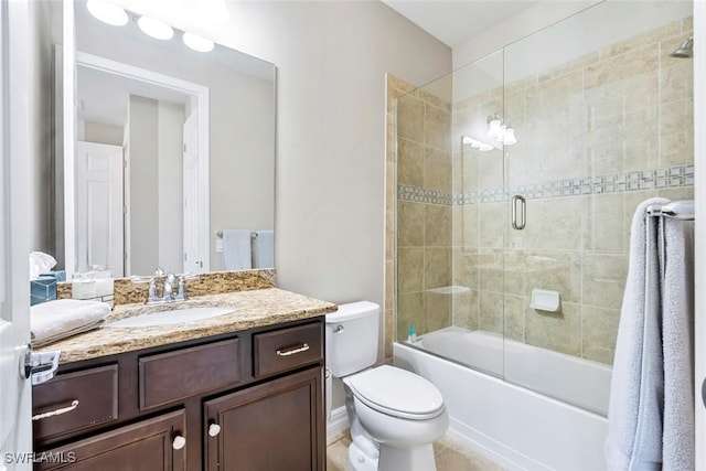 full bathroom with combined bath / shower with glass door, toilet, and vanity