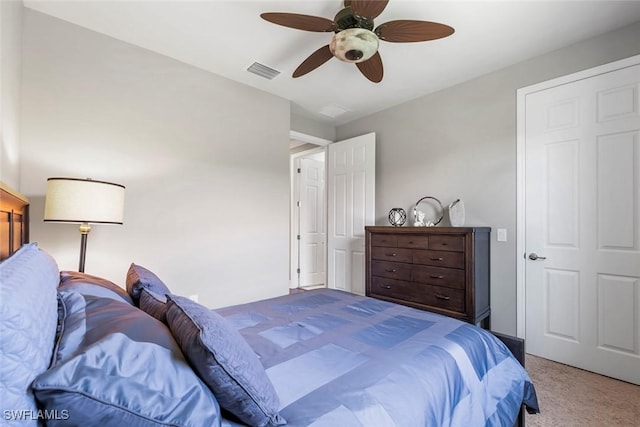 bedroom with carpet, visible vents, and ceiling fan